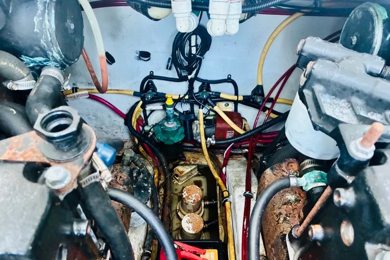 Slide: The Image of Engine compartment of a 2002 Pursuit 3000 Express boat with visible hoses and components. - 35