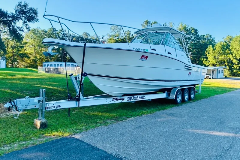 Slide: The Image of 2002 Pursuit 3000 Express boat on trailer, parked outdoors, for sale. - 15