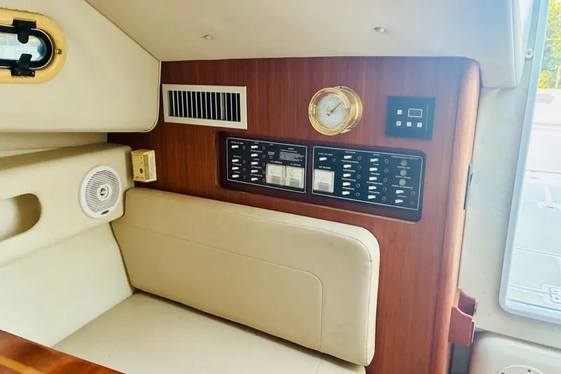 Slide: The Image of Interior of 2002 Pursuit 3000 Express boat with control panel and seating. - 49