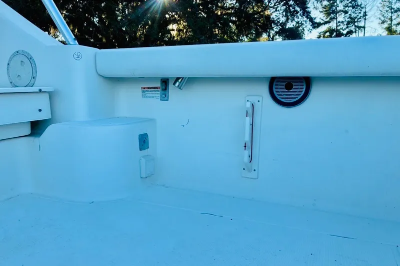 Slide: The Image of 2002 Pursuit 3000 Express boat interior with seating and storage compartments. - 77