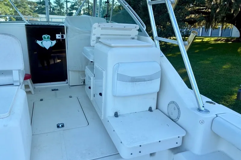 Slide: The Image of 2002 Pursuit 3000 Express boat interior with seating and storage compartments. - 26