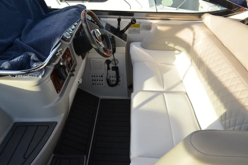Slide: The Image of Interior of a 2002 Formula 37 Performance Cruiser with white seating and steering wheel. - 25