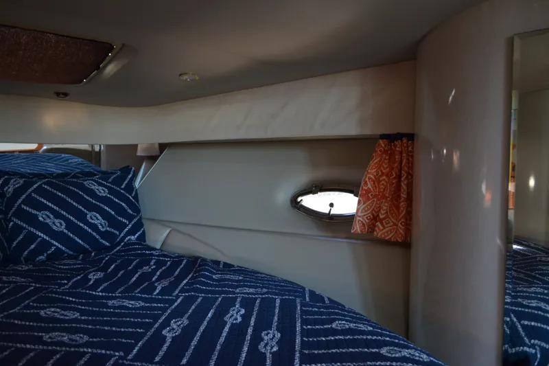 Slide: The Image of Interior cabin of 2002 Formula 37 Performance Cruiser with nautical bedding and porthole. - 49