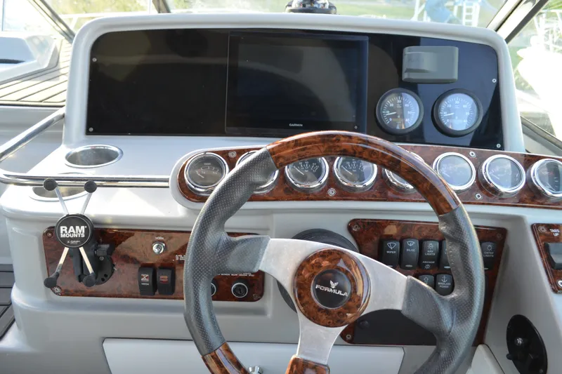 Slide: The Image of 2002 Formula 37 Performance Cruiser dashboard with steering wheel and instrument panel. - 28