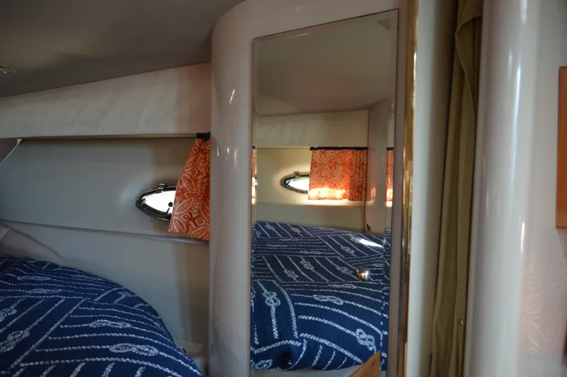 Slide: The Image of Interior of 2002 Formula 37 Performance Cruiser with patterned bedding and orange curtains. - 51