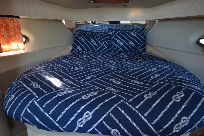 Slide: The Image of Interior cabin of 2002 Formula 37 Performance Cruiser with nautical-themed bedding. - 48