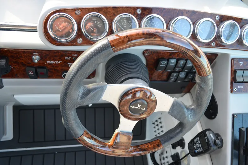 Slide: The Image of Steering wheel and dashboard of a 2002 Formula 37 Performance Cruiser boat. - 29