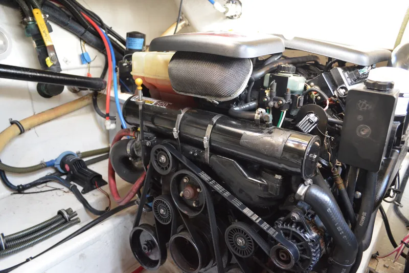 Slide: The Image of Engine compartment of a 2002 Formula 37 Performance Cruiser with visible belts and hoses. - 69