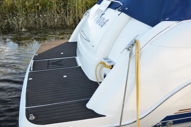 Slide: The Image of 2002 Formula 37 Performance Cruiser with swim platform and mooring line by the water. - 12
