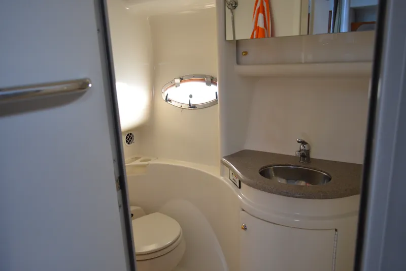 Slide: The Image of 2002 Formula 37 Performance Cruiser bathroom with sink, toilet, and porthole window. - 61