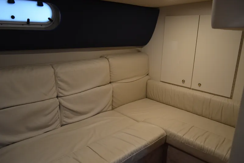 Slide: The Image of Interior of 2002 Formula 37 Performance Cruiser with beige leather seating and storage cabinets. - 58