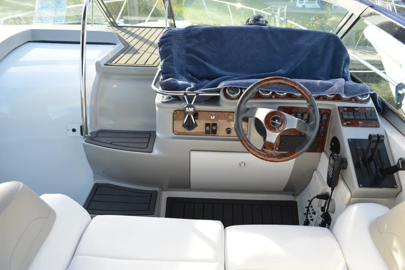 Slide: The Image of 2002 Formula 37 Performance Cruiser helm with wood accents and modern controls. - 27