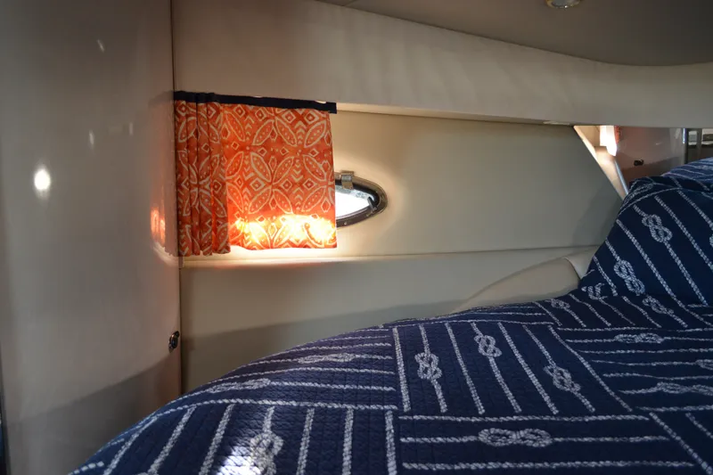 Slide: The Image of Interior cabin of 2002 Formula 37 Performance Cruiser with patterned curtains and bedding. - 50