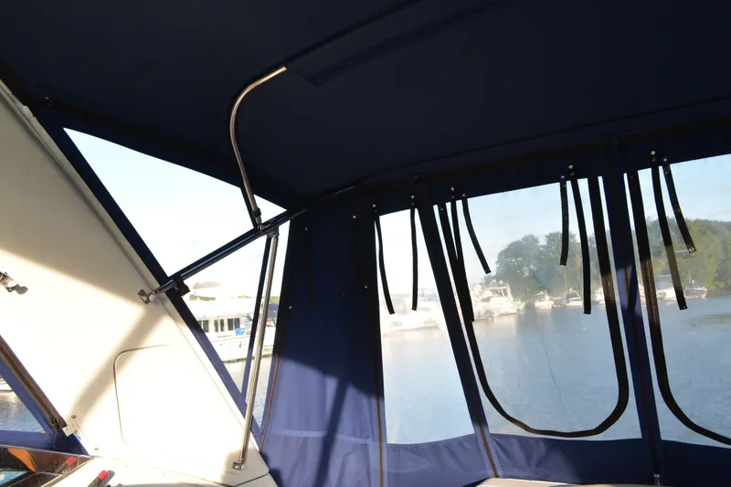 Slide: The Image of Interior view of 2002 Formula 37 Performance Cruiser with blue canopy and marina backdrop. - 16