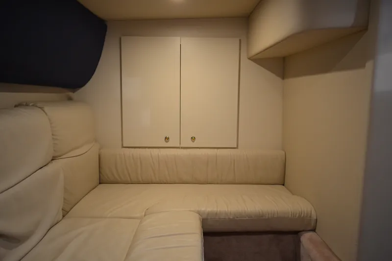 Slide: The Image of Interior of 2002 Formula 37 Performance Cruiser with beige seating and storage cabinets. - 59