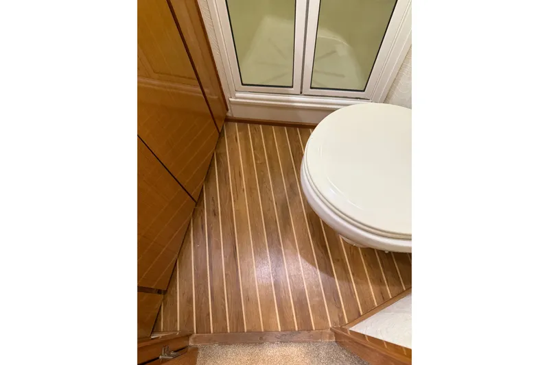 Slide: The Image of Bathroom interior of 2002 Viking 52 Convertible yacht with wooden flooring. - 33