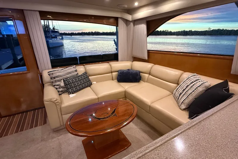 Slide: The Image of Luxurious interior of 2002 Viking 52 Convertible yacht with leather seating and scenic water view. - 53