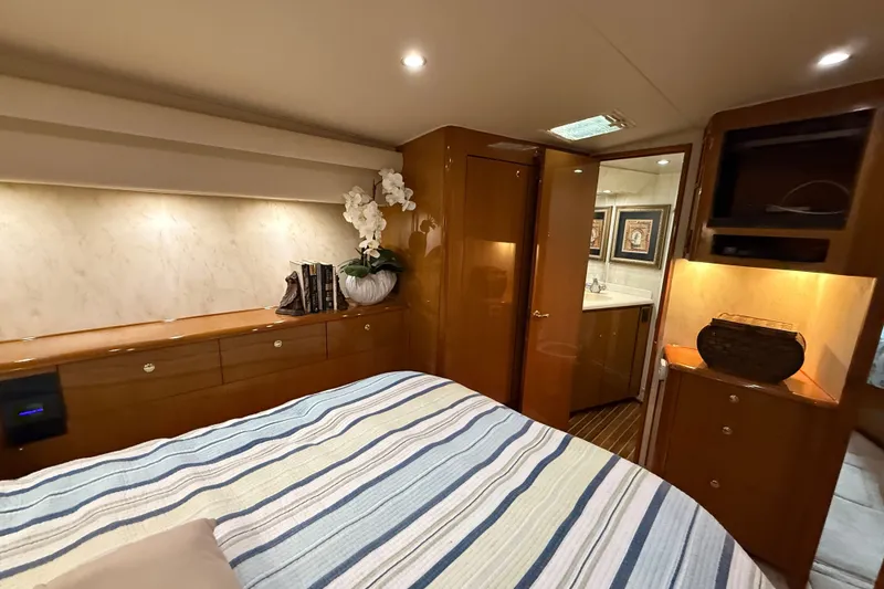 Slide: The Image of Luxurious cabin interior of a 2002 Viking 52 Convertible yacht with elegant decor. - 30
