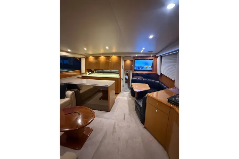 Slide: The Image of Luxurious interior of a 2002 Viking 52 Convertible yacht with modern furnishings and ambient lighting. - 55