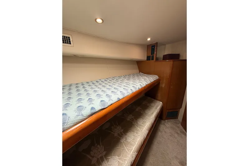 Slide: The Image of Interior of 2002 Viking 52 Convertible yacht with bunk beds and wooden cabinetry. - 38