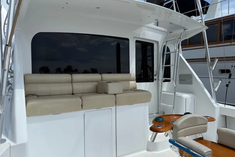 Slide: The Image of 2002 Viking 52 Convertible yacht interior with beige seating and fishing chair. - 6