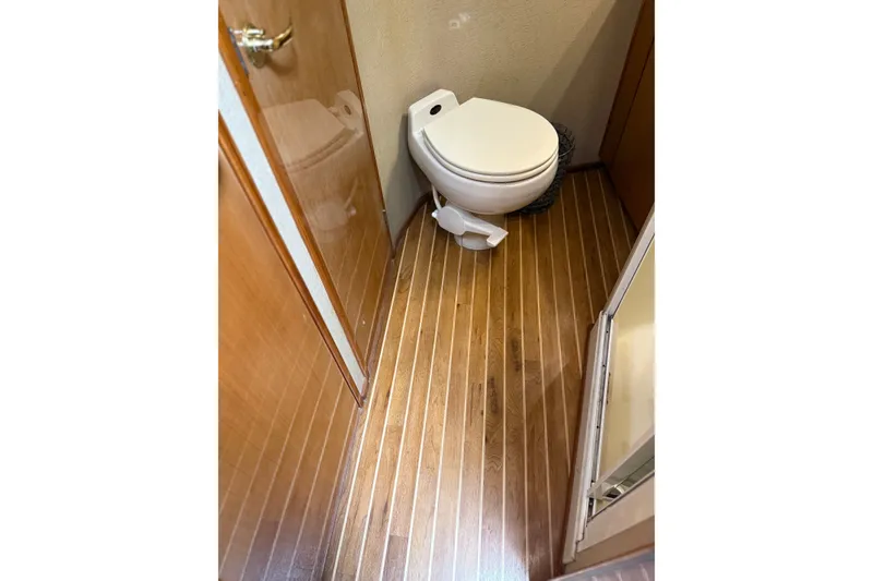 Slide: The Image of Bathroom interior of 2002 Viking 52 Convertible yacht with wooden flooring. - 41