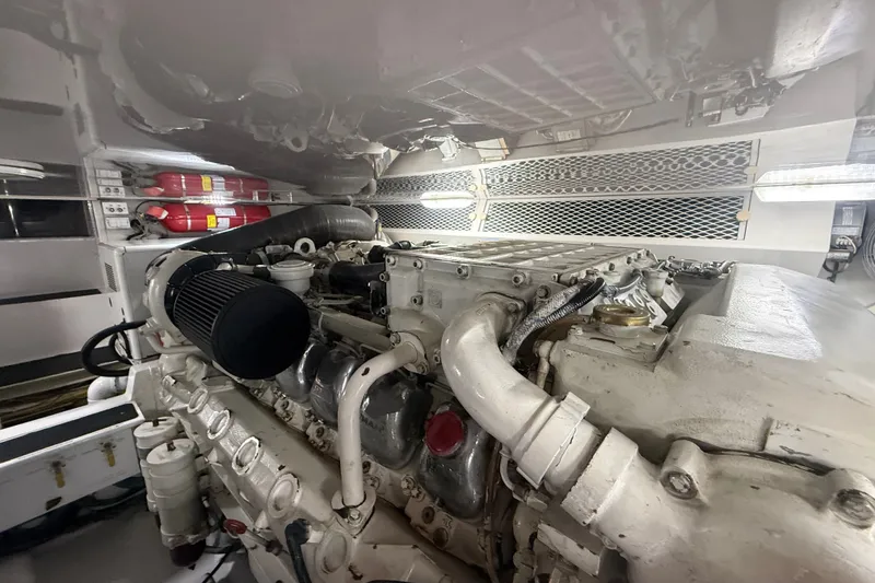Slide: The Image of Engine room of a 2002 Viking 52 Convertible yacht, showcasing detailed machinery. - 49