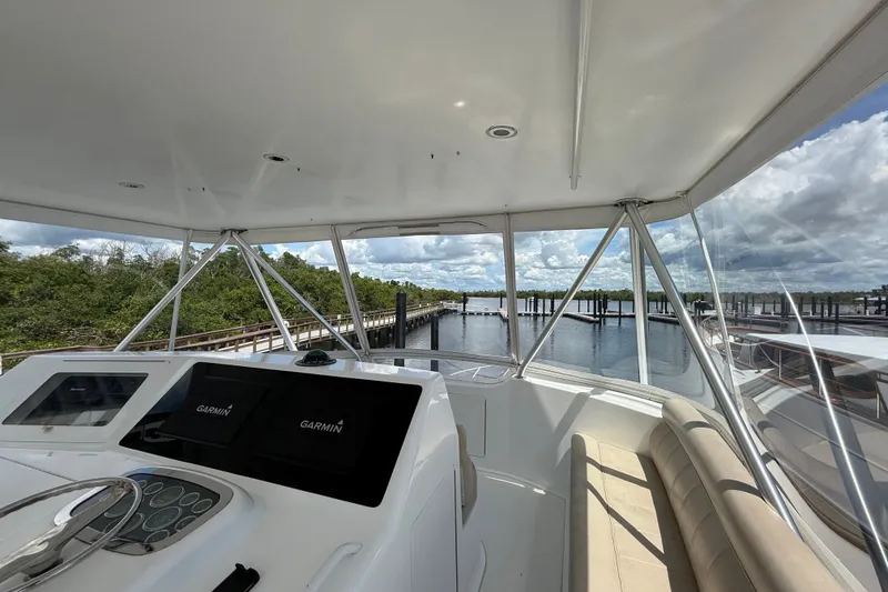 Slide: The Image of Helm view of 2002 Viking 52 Convertible yacht with Garmin navigation, dockside setting. - 12