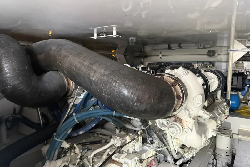 Slide: The Image of Engine room of a 2002 Viking 52 Convertible yacht, showcasing complex machinery and piping. - 45