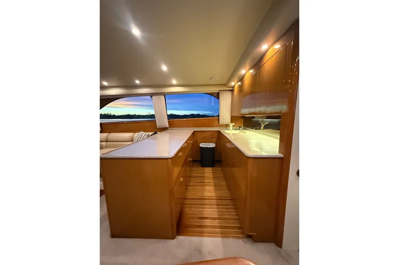 Slide: The Image of Luxurious interior of 2002 Viking 52 Convertible yacht with elegant wood cabinetry and modern lighting. - 54