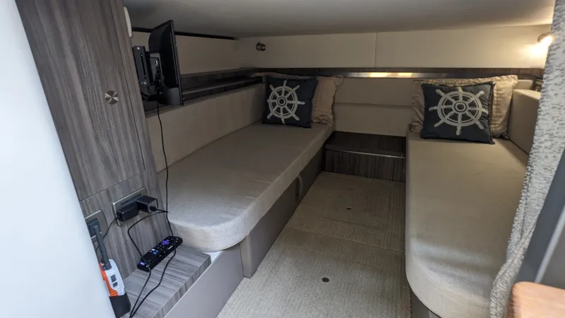 Slide: The Image of Interior of a Sea Ray Sundancer 320 Outboard with two single beds and a small TV. - 19