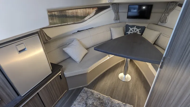 Slide: The Image of Interior of a Sea Ray Sundancer 320 Outboard with a cozy seating area and table. - 22