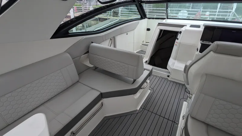 Slide: The Image of The image shows the cockpit of a 2021 Sea Ray Sundancer 320 Outboard with gray upholstery. - 5