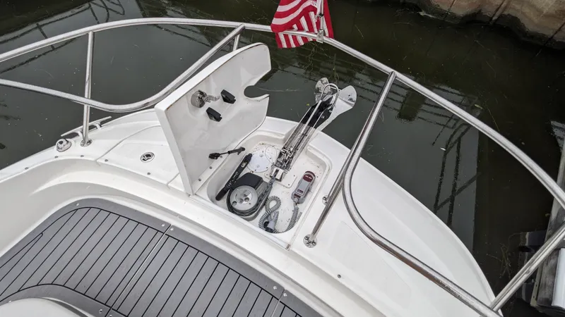 Slide: The Image of The image shows the bow deck of a 2021 Sea Ray Sundancer 320 Outboard with an anchor chain. - 26