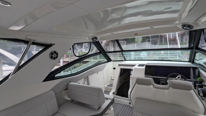 Slide: The Image of Interior view of a modern yacht with gray seating and large windows. - 6