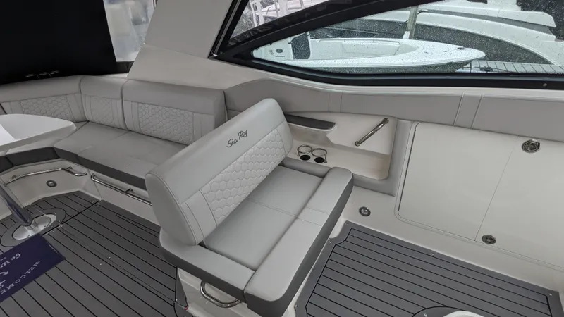 Slide: The Image of The image shows the interior of a Sea Ray Sundancer 320 Outboard with gray upholstery and sleek details. - 8