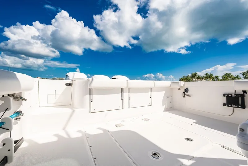 Slide: The Image of The image shows the spacious, white deck of an Everglades 350LX boat under a blue sky. - 28