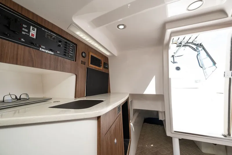 Slide: The Image of Interior of a 2019 Everglades 350LX with sleek wood paneling and modern amenities. - 27