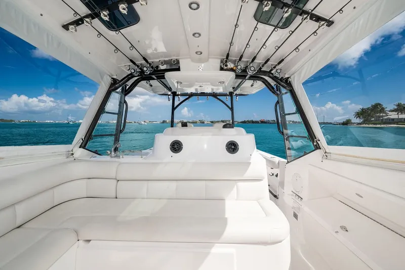 Slide: The Image of The image shows the cockpit of a 2019 Everglades 350LX with white seating and a clear view of the sea. - 19