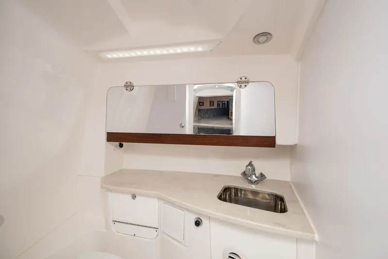 Slide: The Image of The image shows a sleek boat bathroom with a sink and mirror. - 24