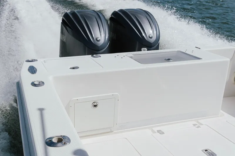 Slide: The Image of 2014 SeaVee 320B boat with dual Yamaha engines cruising on water. - 14