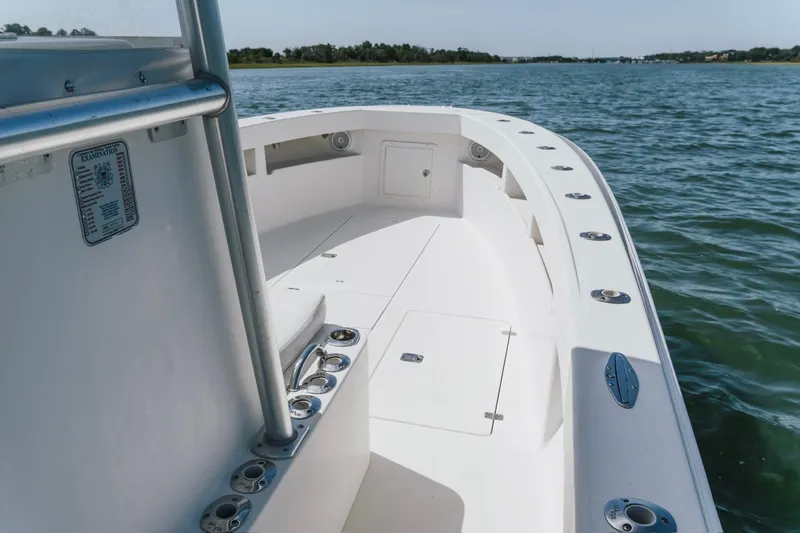 Slide: The Image of 2014 SeaVee 320B boat on calm water, showcasing spacious deck and sleek design. - 15