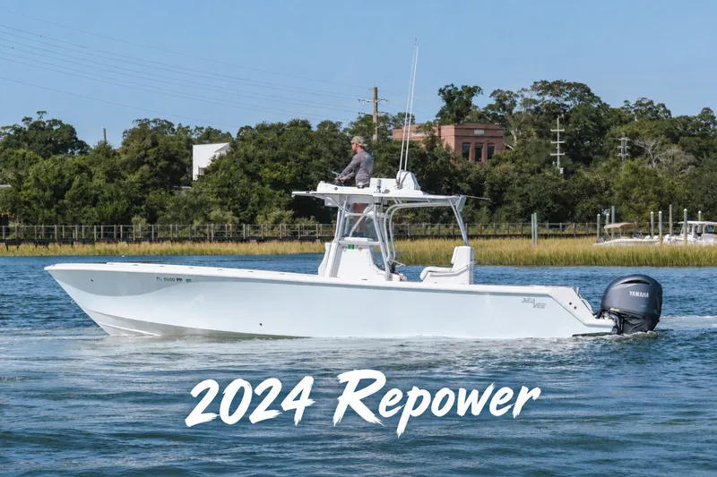 The Image of 2014 SeaVee 320B boat with 2024 repower, cruising on a scenic waterway. - 1