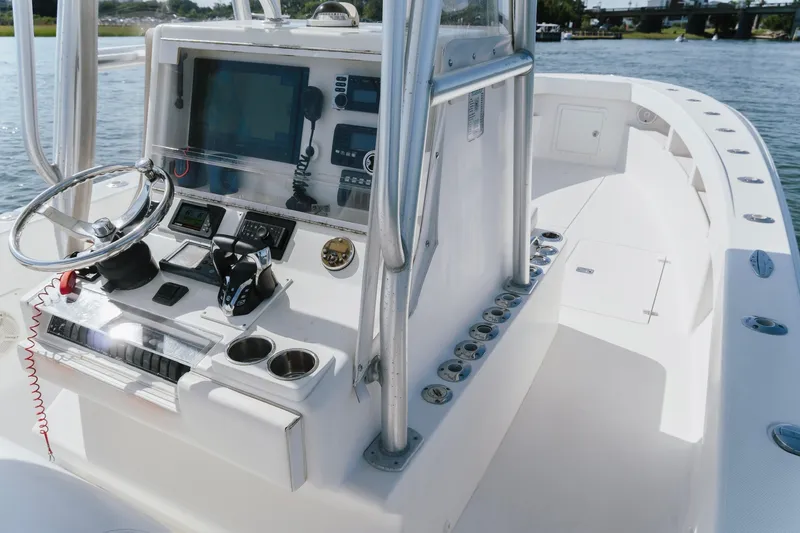Slide: The Image of 2014 SeaVee 320B boat cockpit with steering wheel, navigation controls, and cup holders. - 17