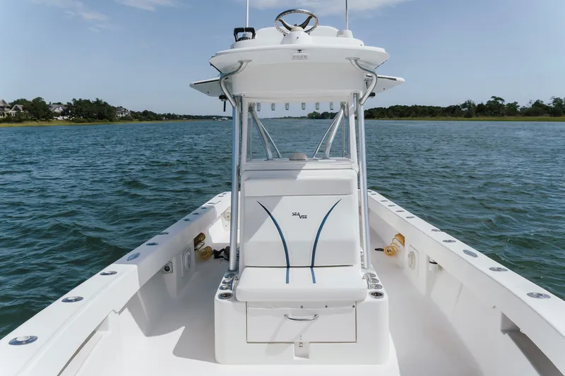 Slide: The Image of 2014 SeaVee 320B boat on calm water, showcasing center console and seating. - 19