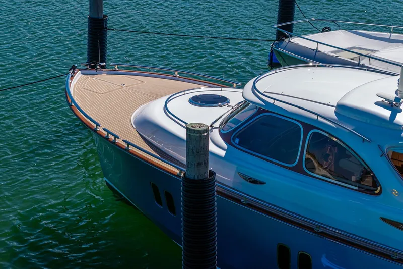 Slide: The Image of 2014 Zeelander Z44 yacht docked on calm water, showcasing sleek design and luxury features. - 4