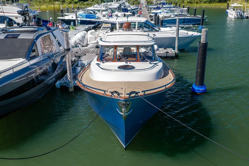 Slide: The Image of 2014 Zeelander Z44 yacht docked at marina, surrounded by other boats. - 6