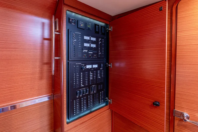Slide: The Image of Electrical panel inside 2014 Zeelander Z44 yacht with wooden cabinetry. - 43