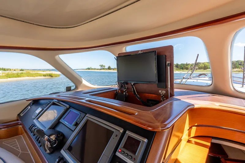 Slide: The Image of Interior view of 2014 Zeelander Z44 yacht cockpit with navigation screens and scenic waterway. - 41