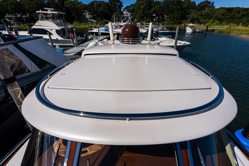 Slide: The Image of 2014 Zeelander Z44 yacht docked in a marina, surrounded by other boats. - 22